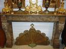 A brownish marble Regence style fire mantle