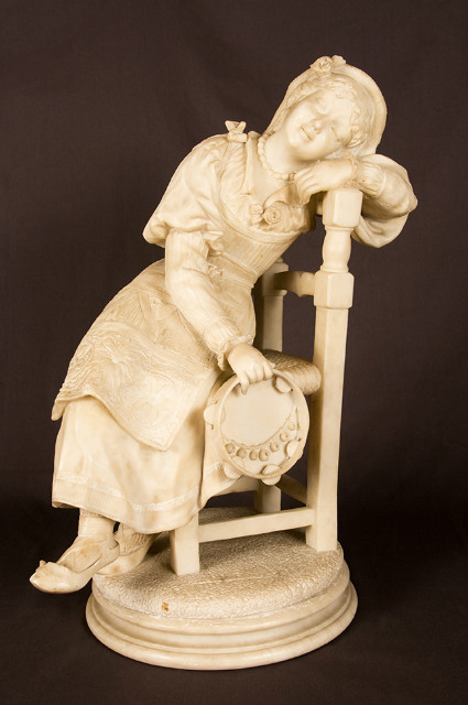 Alabaster sculpture of a seated girl with tambourine in traditional costume France 19th Century