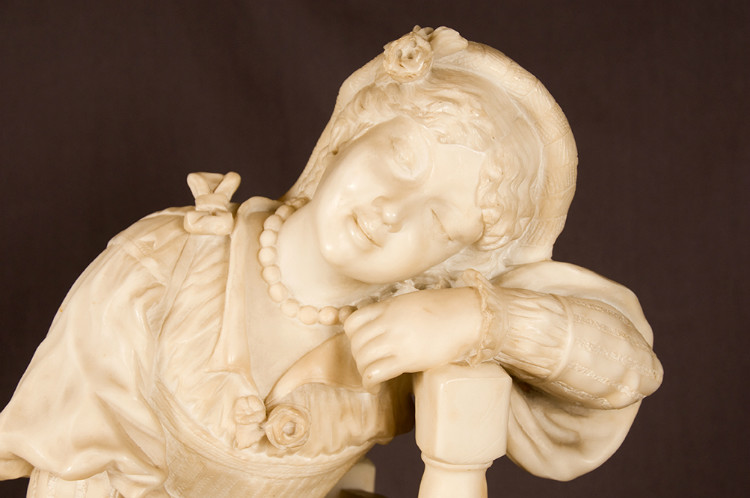 Alabaster sculpture of a seated girl with tambourine in traditional costume France 19th Century
