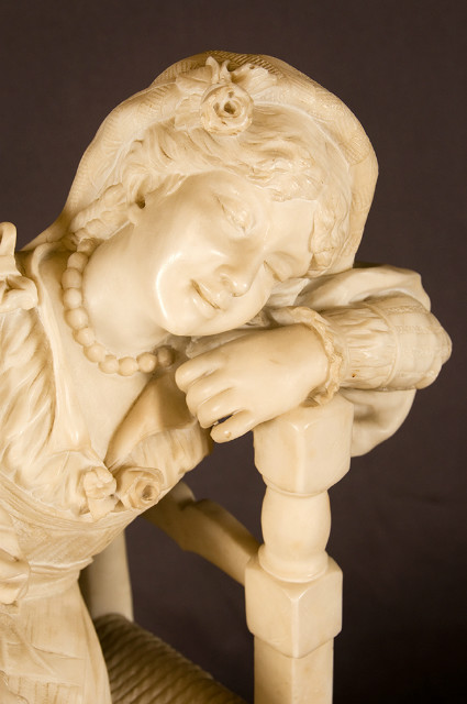 Alabaster sculpture of a seated girl with tambourine in traditional costume France 19th Century