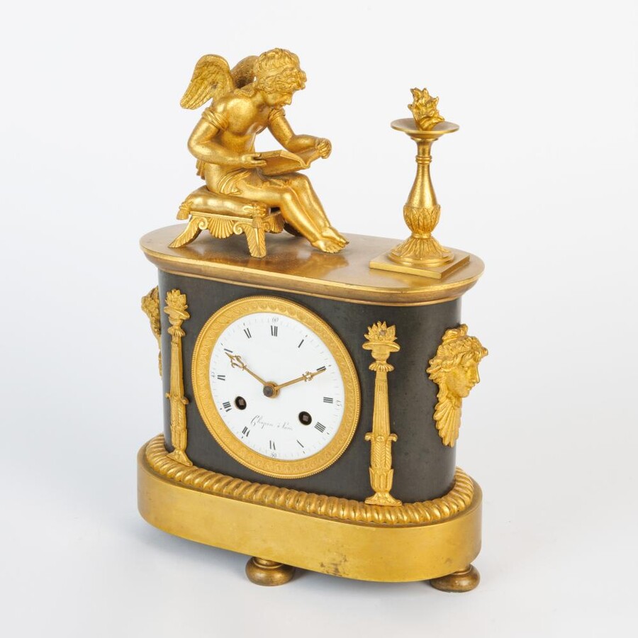 An Empire clock with a reading putti