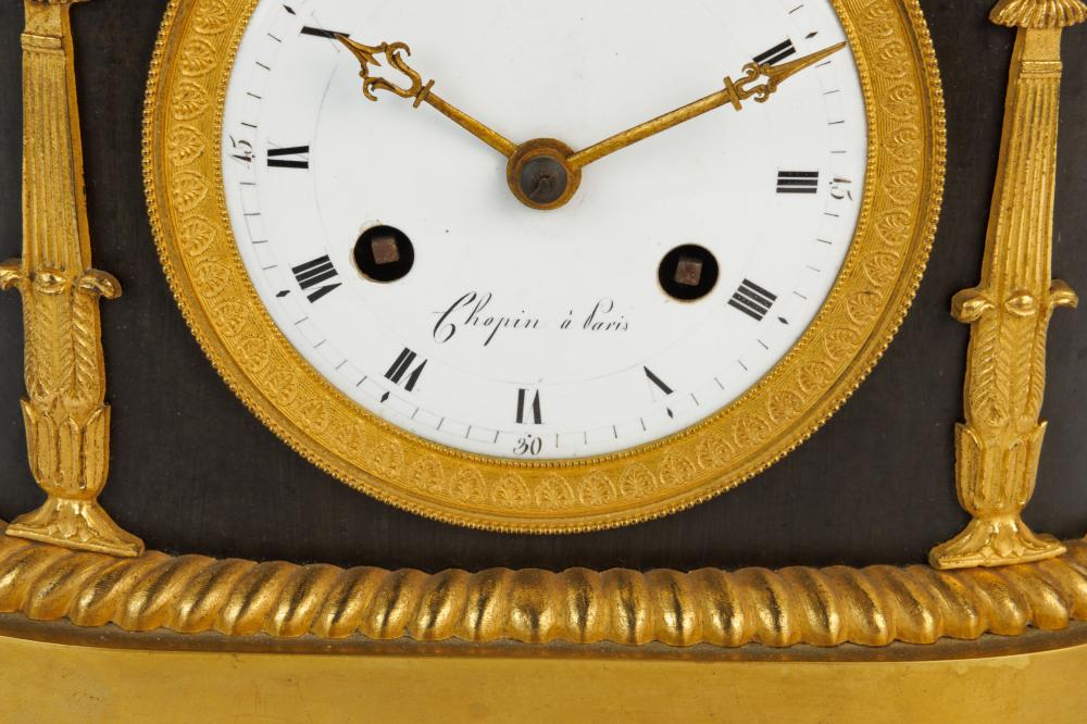 An Empire clock with a reading putti